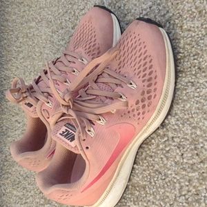 Peach colored Nike tennis shoes